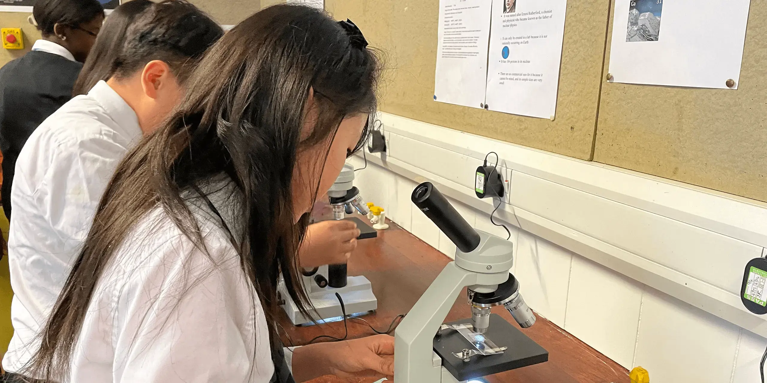 St. Mary's Music School pupil uses a microscope in a science lesson