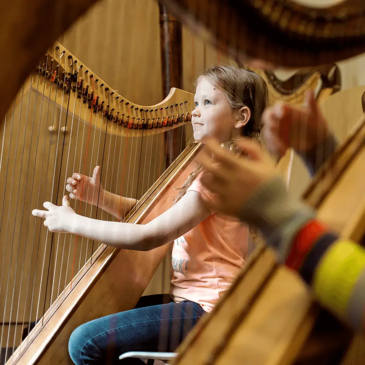 St Mary's Music School pupils playing the harp in a group lesson