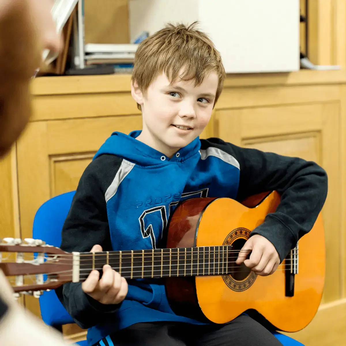 St Mary's Music School pupil playing the guitar