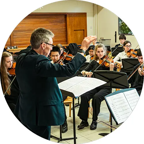 St. Mary's Music School Senior Orchestra rehearsal with conductor